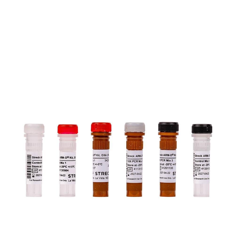 Six Streck ARM-D® vials for OXA, PCR Mix, and Control Mix, each with distinct colored caps (clear, red, brown, black) and labels displaying product information, storage instructions, and lot numbers.